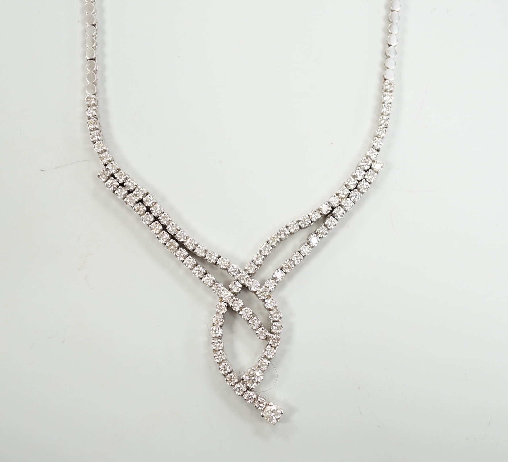 A modern 750 white metal and diamond set interwoven necklace, approx. 44cm, gross weight 28.1 grams.